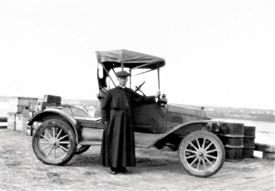 Denis Doucet in piedi accanto alla sua automobile